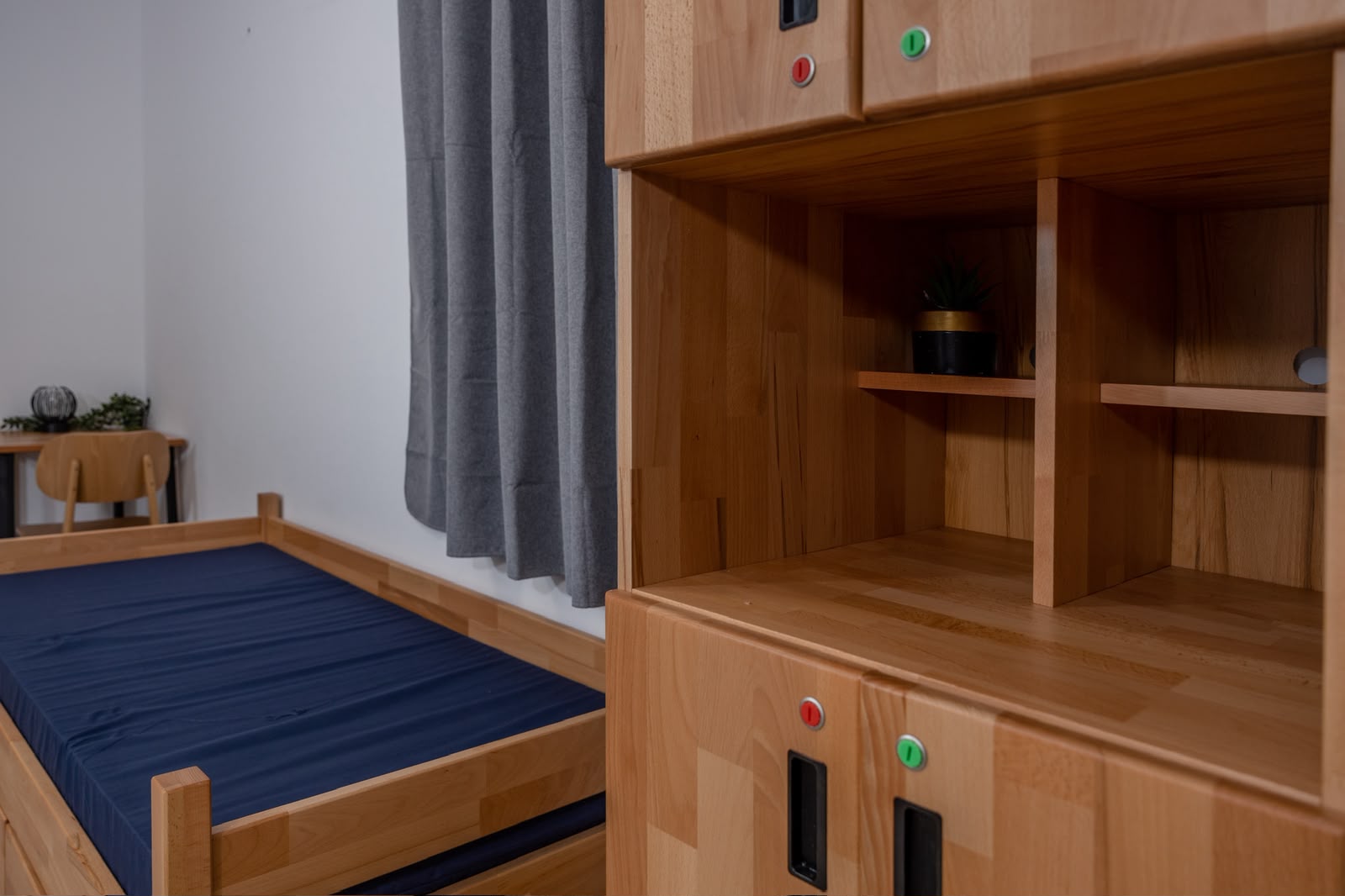 Natural wood bed and storage for a yeshiva student room