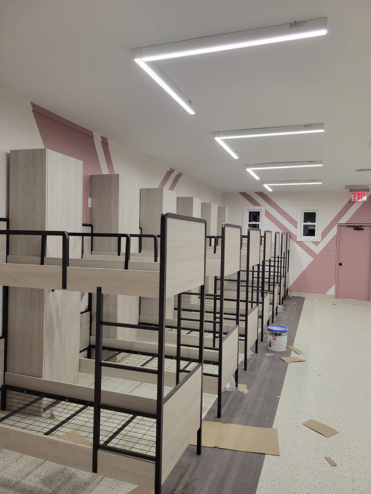 Rows of two-tone bunk beds for a yeshiva dormitory layout